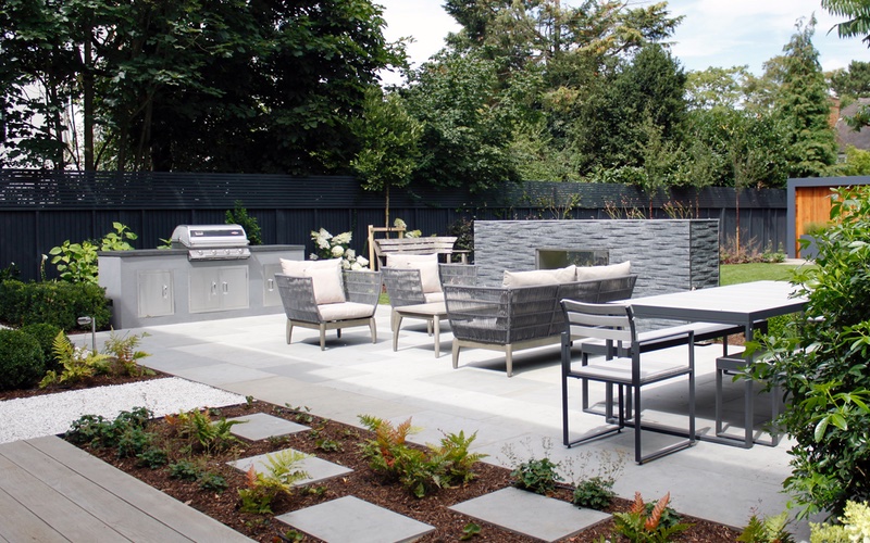 Grey Yorkstone and Millboard installed by Landscaping Solutions.